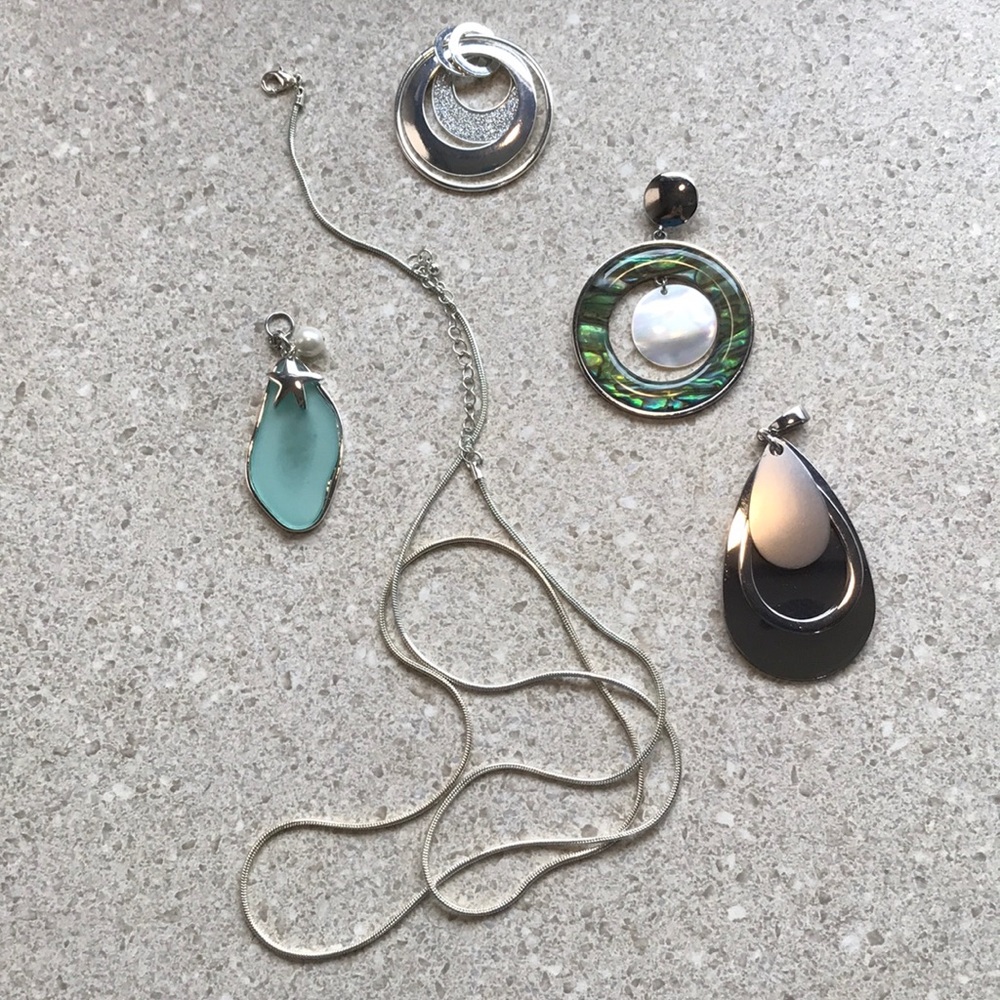 Long silver fluid necklace with several pendants